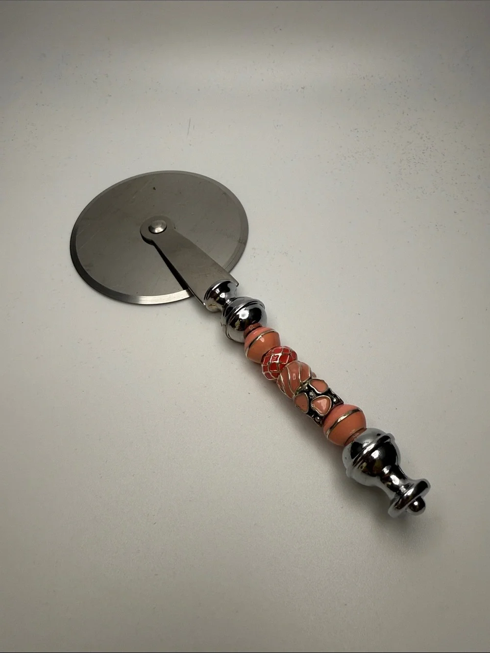 Decorative Coral-Peach Beaded Pizza Cutter with Chrome Handle